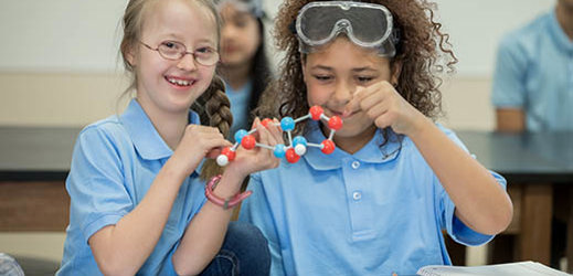 two students working with molecular model