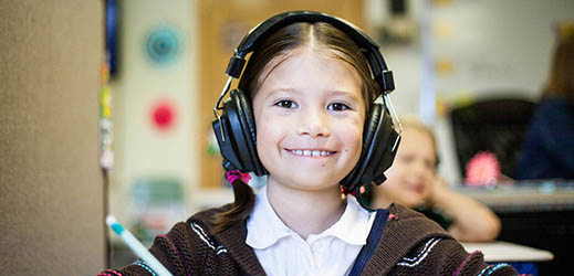 Student in classroom wearing headphones
