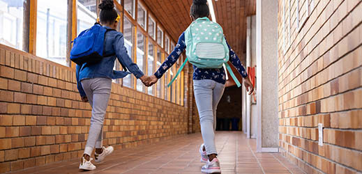 two students walking down hallway